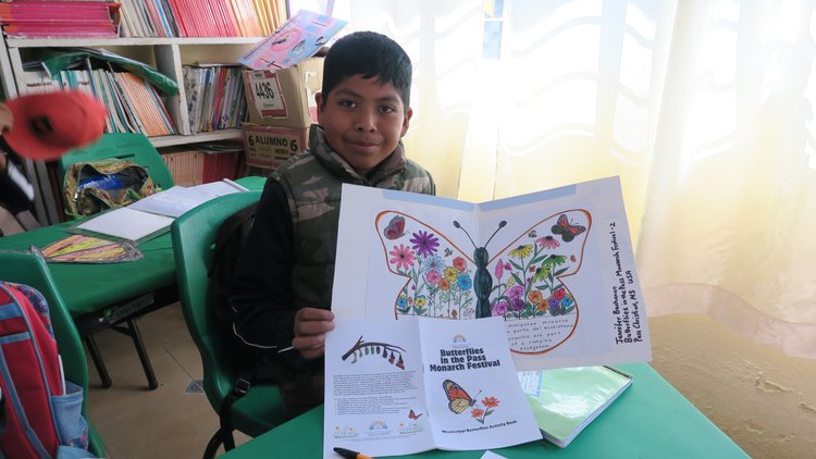 A student in Mexico displays a gift sent as part of the Symbolic Migration Project