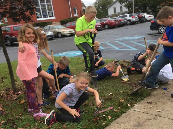 Kids planting tulip bulbs.