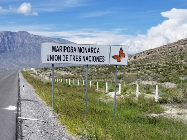 "Monarch Butterfly union of three nations," says the road sign near the border.