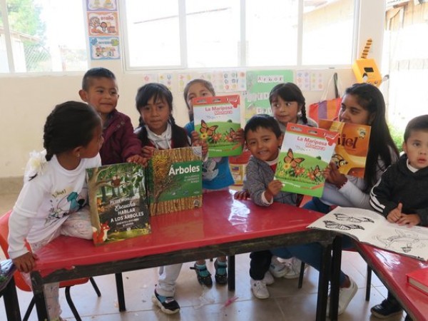 Students holding monarch books
