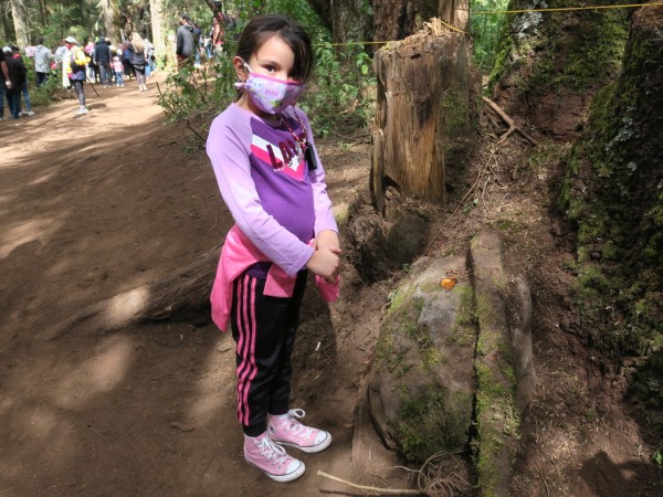 photo of girl in Mexico pointing to a monarch