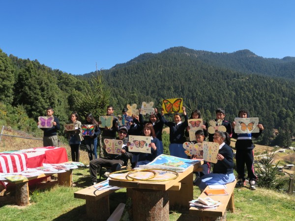 children holding up ambassador butterflies