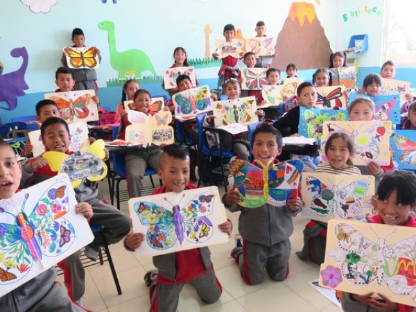 children holding up ambassador butterflies