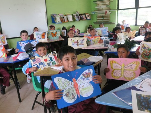 students holding up ambassador butterflies