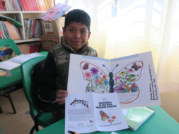 A student in Mexico displays a gift sent as part of the Symbolic Migration Project